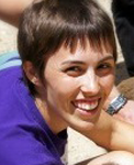 Dr. Abigail Love smiles at the camera while outside in a group of people.