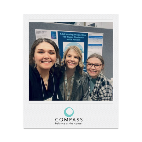 Polaroid of 3 COMPASS students standing in front of a bulletin board at a conference.